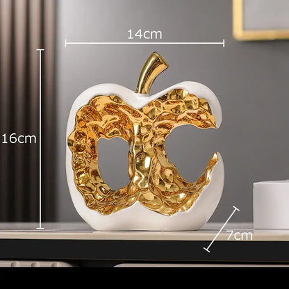 Modern white ceramic apple sculpture with metallic gold interior and stem for desk decoration and living room decor