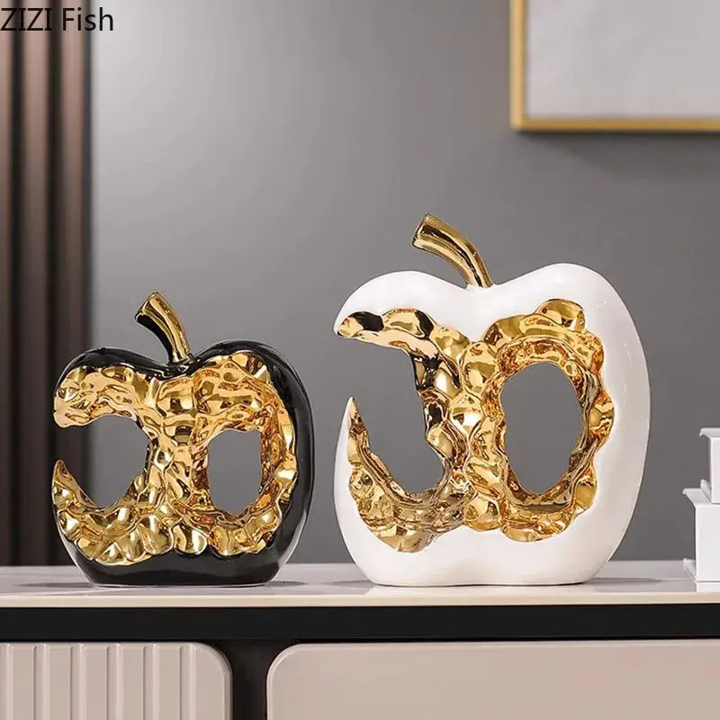 Modern white and black ceramic apple sculpture with glossy finish and textured gold interior for desk decoration