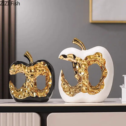 Modern white and black ceramic apple sculpture with glossy finish and textured gold interior for desk decoration