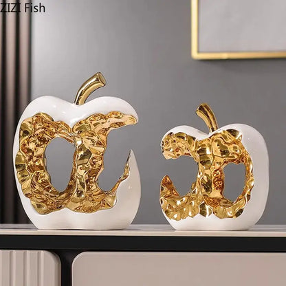 Modern white ceramic apple sculpture with gold leaf and metallic stem perfect for desk decoration or living room decor