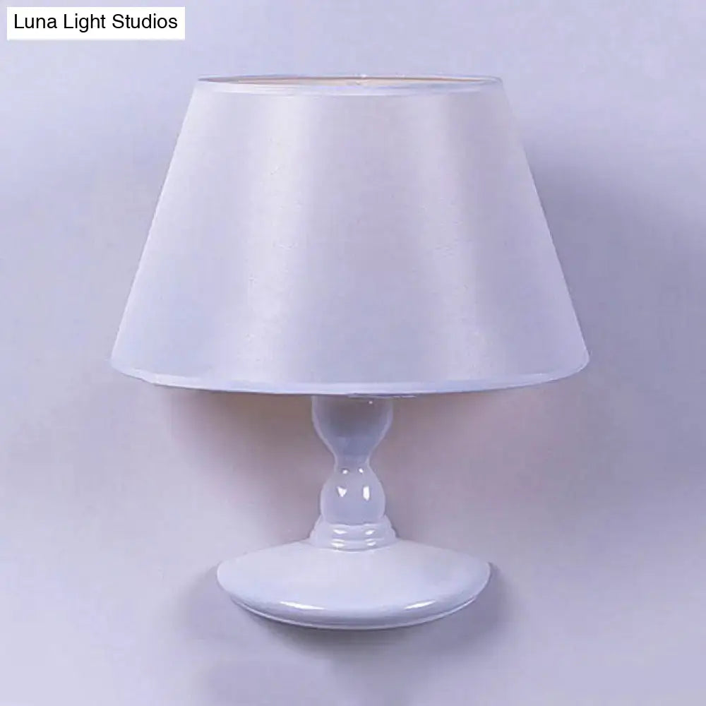 Modern white black cone ceramic wall sconce with white satin lampshade and glossy white ceramic base for bedroom lighting
