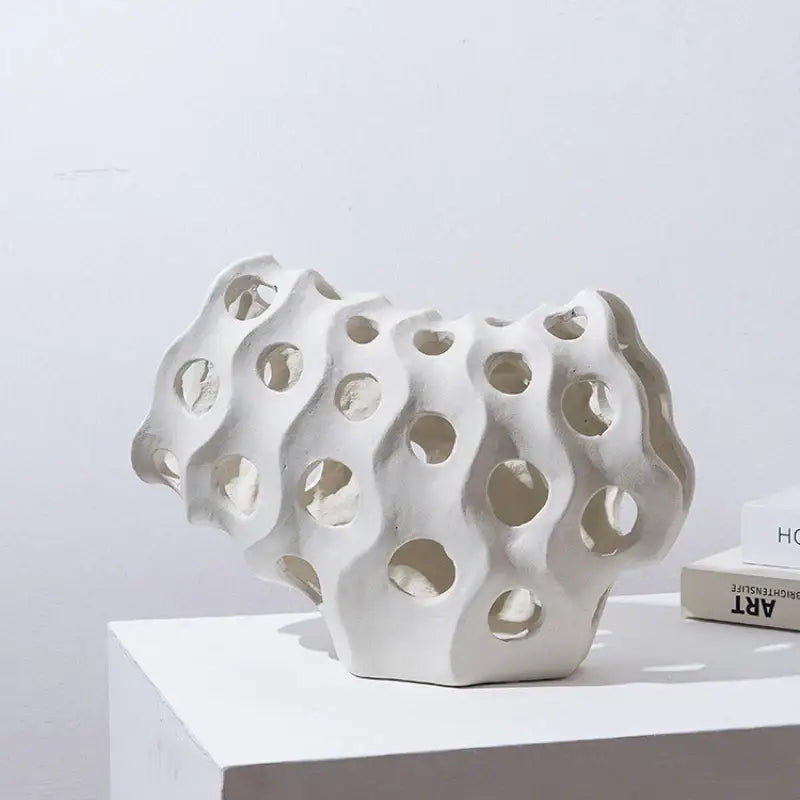 Modern white coral geometric resin sculpture with wavy porous design and circular holes for living room decor