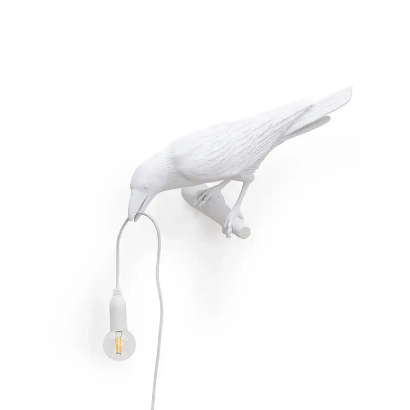 Modern white ceramic wall lamp with exposed bulb hanging from beak decorbites designer bird wall decor