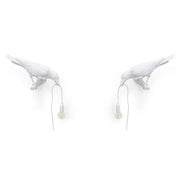 Modern white ceramic wall lamp by decorbites designer bird featuring black crow shape holding small bulbs for bedroom light decor