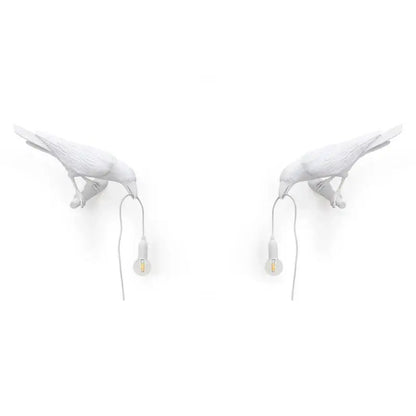 Modern white ceramic wall lamp by decorbites designer bird featuring black crow shape holding small bulbs for bedroom light decor