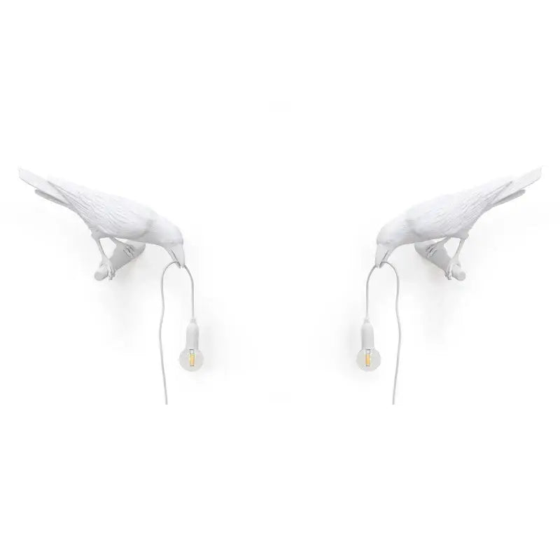 Modern white ceramic wall lamp by decorbites designer bird featuring black crow shape holding small bulbs for bedroom light decor