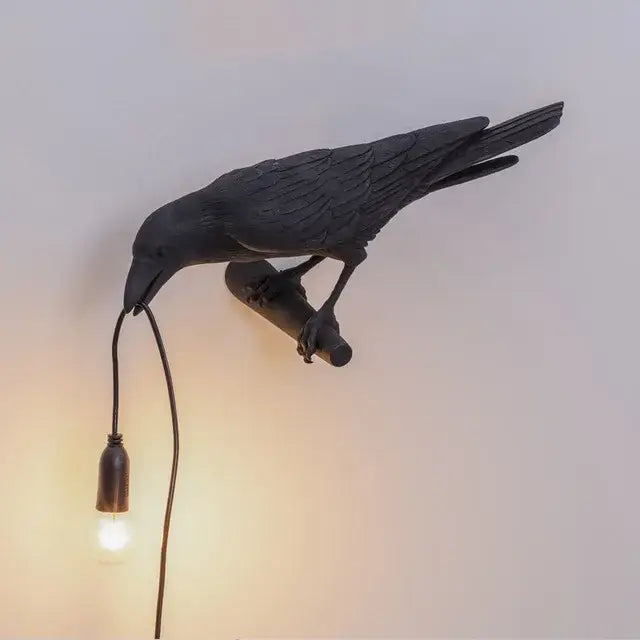 Modern white and black designer bird wall lamp featuring a black crow shape with detailed feathers and vintage bulb decorbites wall lamp