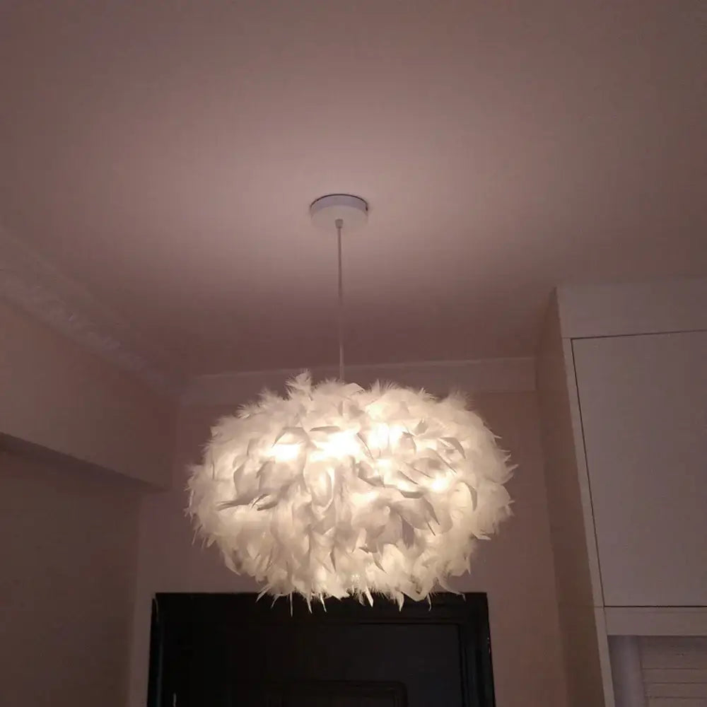 Modern white feather pendant light with a soft fluffy cloud-like design for bedroom lighting