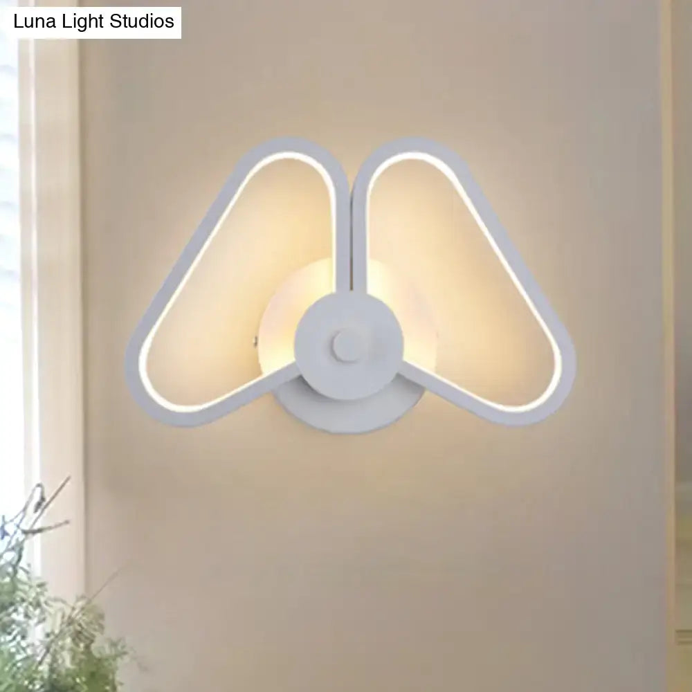 Modern white and black led triangle wall sconce with butterfly-wing design and warm ambient lighting for living room