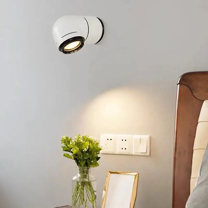 Modern white and black decorbites led wall light featuring adjustable spotlight with warm led bulb for bedroom decor