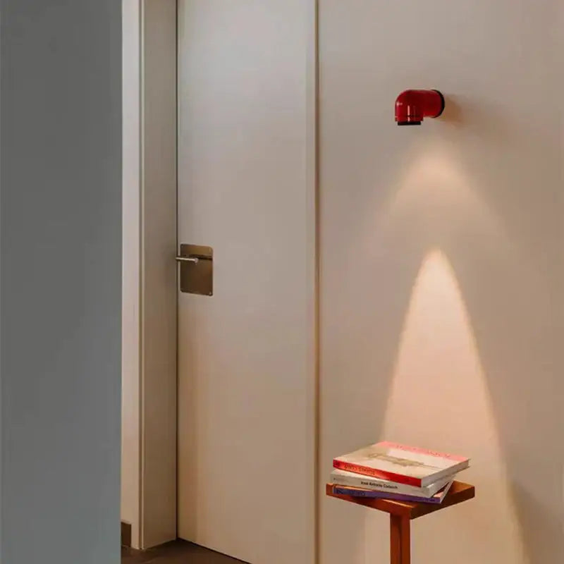 Modern white and black led wall light bedroom sconce with red pipe-style decorbites led wall casting warm focused light