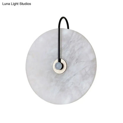 Modern white and black led wall sconce with marble disc shade and black metal arm for bedroom lighting