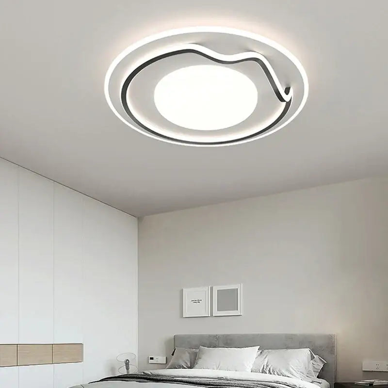 Modern white and black living chandelier lights with a sleek circular design featuring an illuminated central panel and glowing ring