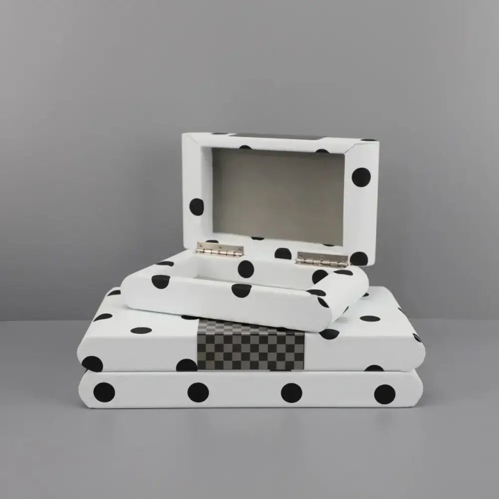 Modern white and black polka dot leather storage box with silver hinge and checkered gray accent strip for bedroom organizing