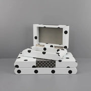 Modern white and black polka dot leather storage box with silver hinge and checkered gray accent strip for bedroom organizing