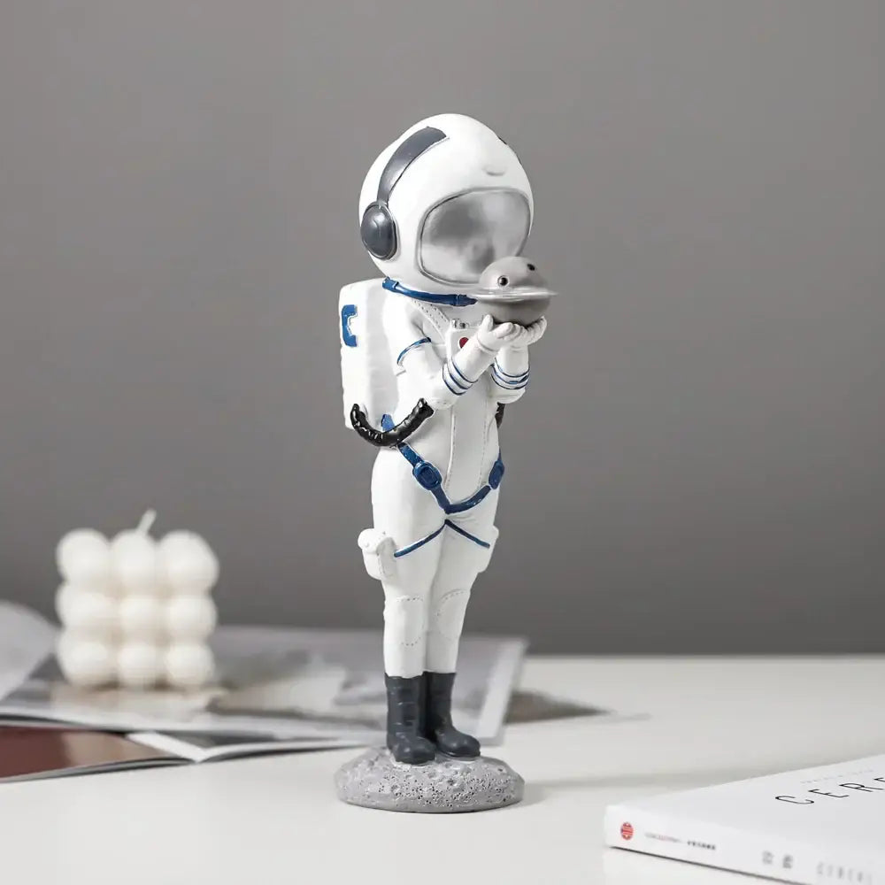 Modern white and blue astronaut resin figurine from decorbites holding a gray moon for living room decor