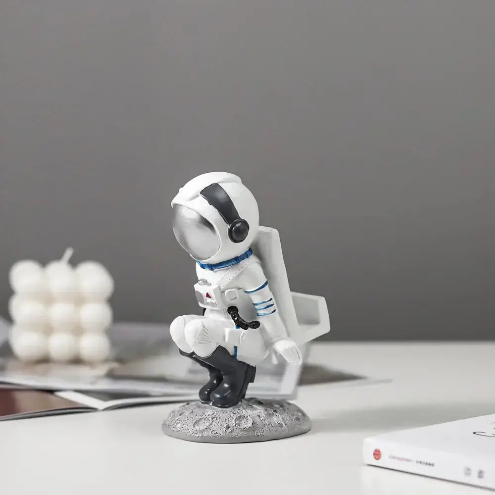 Modern white and blue astronaut resin figurines with reflective silver helmet on textured lunar surface base decorbites astronaut resin