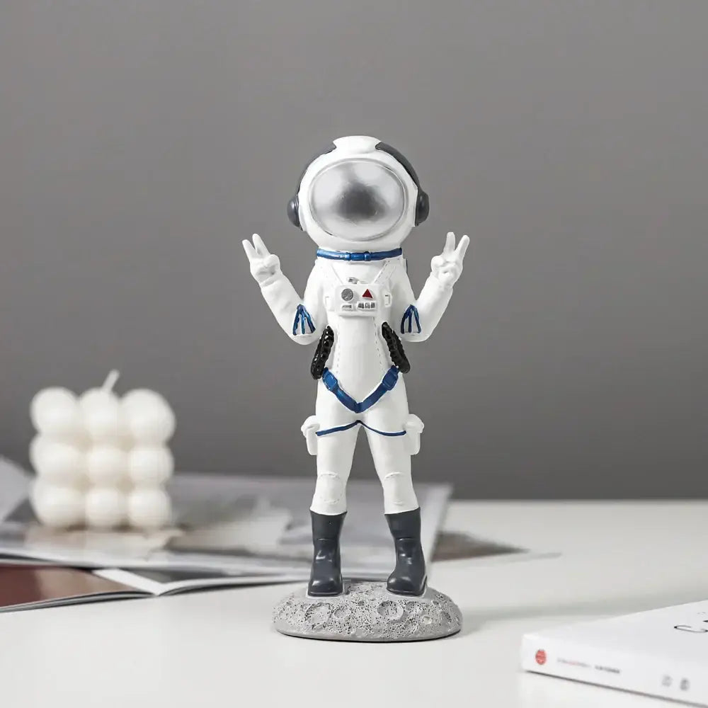 Modern white and blue astronaut resin figurines with silver helmet standing on textured gray lunar surface base decorbites astronaut resin