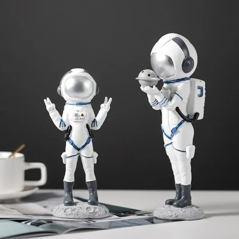 Modern white and blue astronaut resin figurines with silver helmets on gray lunar bases for living room decorbites astronaut decor