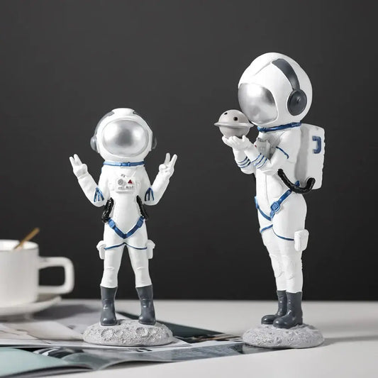 Modern white and blue astronaut resin figurines with silver helmets on gray lunar bases for living room decorbites astronaut decor