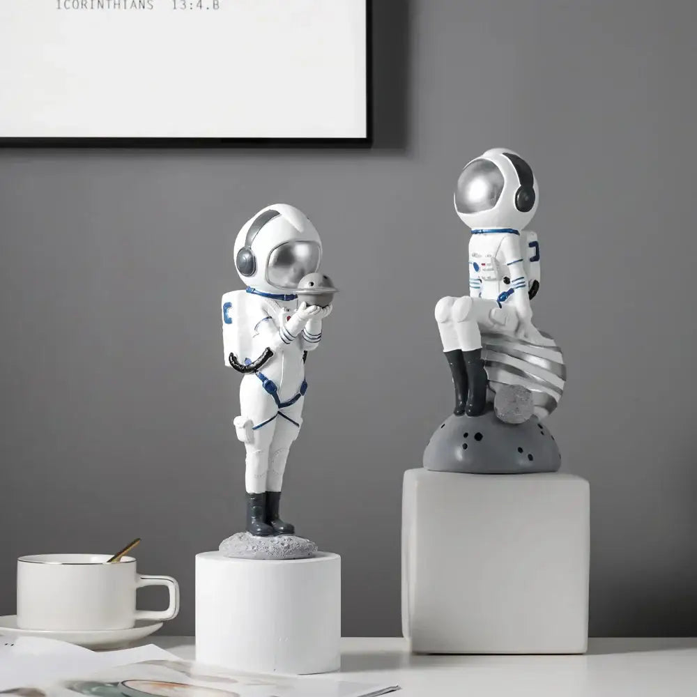 Modern white and blue astronaut resin figurines by decorbites featuring silver helmets for living room decor