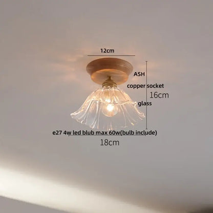 Modern white and brass ceramic led ceiling lamp with a delicate clear glass pendant and wooden ceiling mount