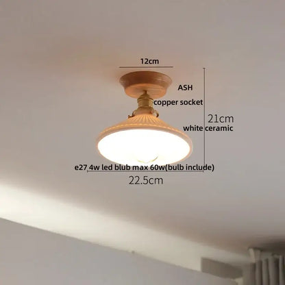 A warm-toned modern white and brass ceramic led ceiling lamp with wooden base and copper socket for bedroom lighting
