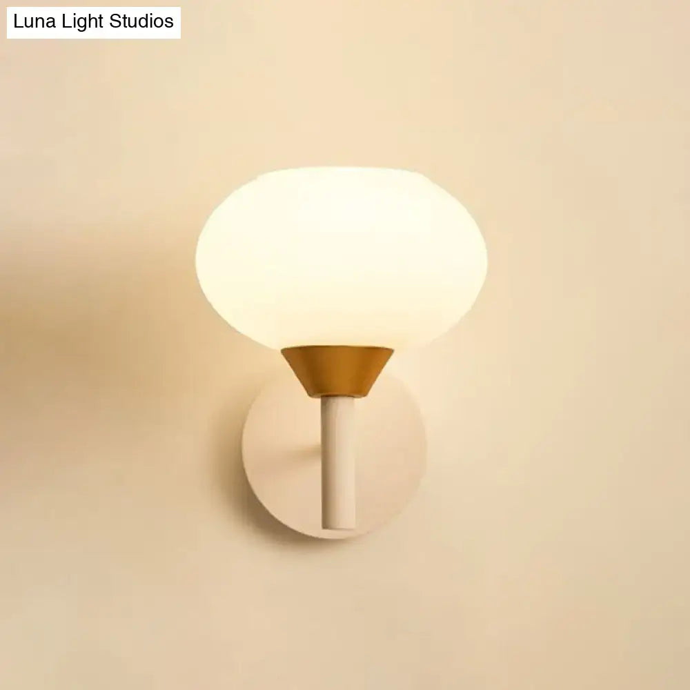 Modern white and brass wall sconce with opal glass frosted globe and conical base for 220v-240v bedroom lighting