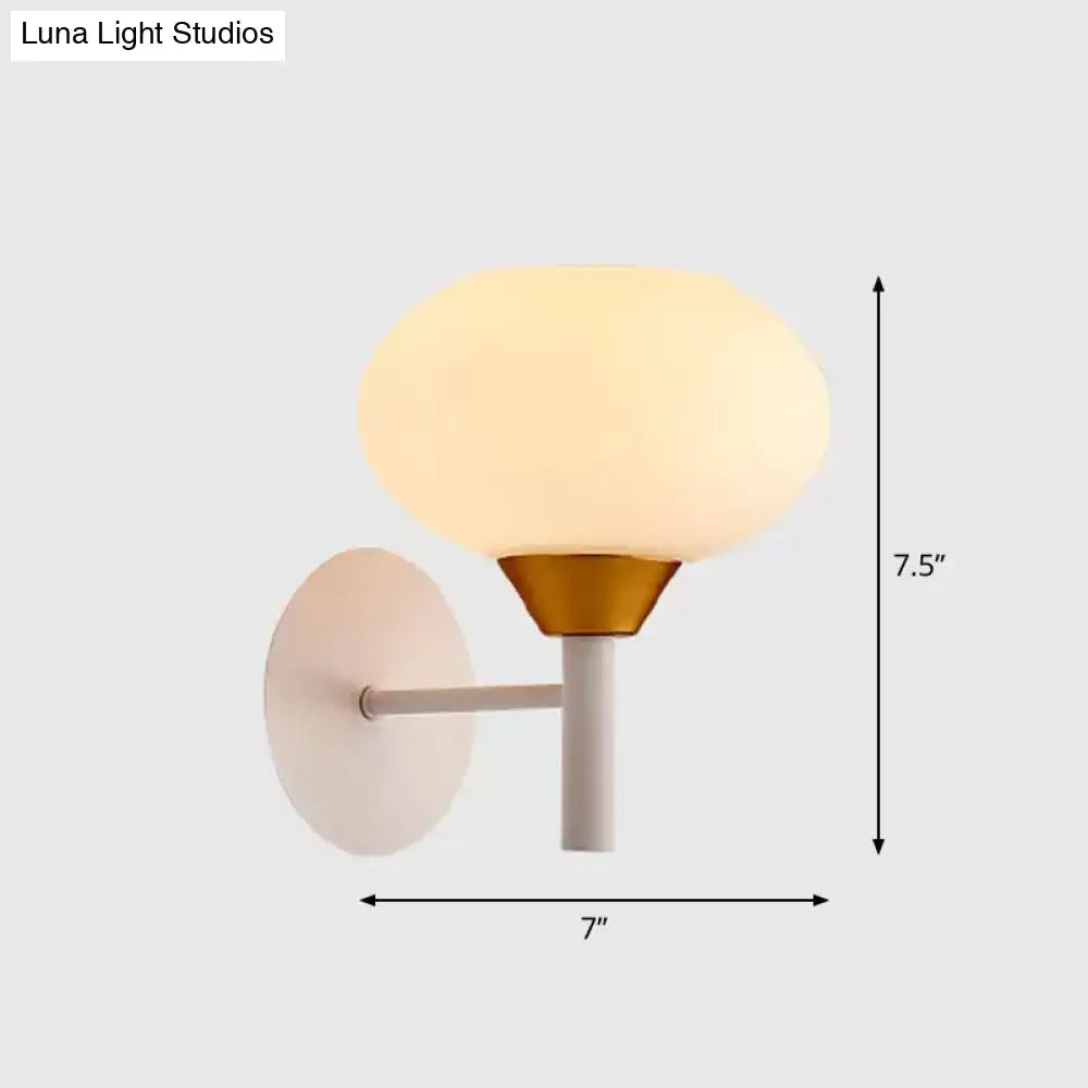 Modern white and brass wall sconce with opal glass globe and matte backplate for 220v-240v bedroom lighting