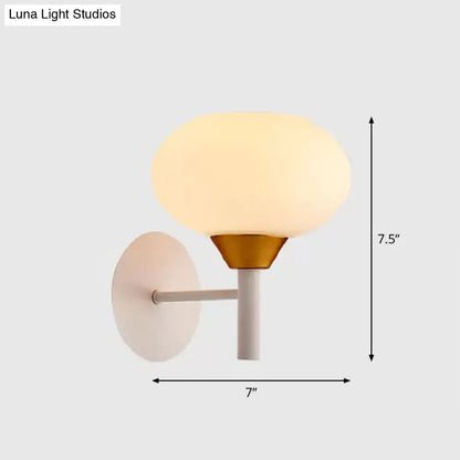 Modern white and brass wall sconce with opal glass globe and matte backplate for 220v-240v bedroom lighting