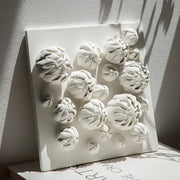 Modern white bud ceramic wall décor pendant featuring raised textured floral forms for bedroom sculptural art