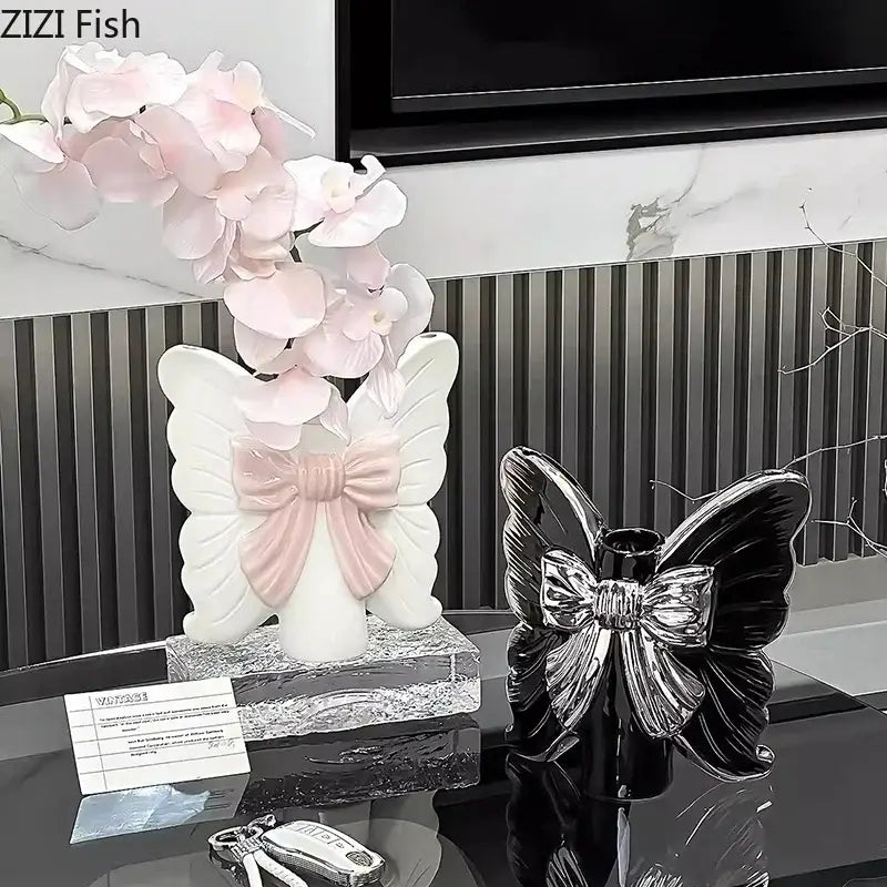 Modern white butterfly ceramic vase with pink bow accent and delicate pink orchid flowers for bedroom decorbites butterfly ceramic