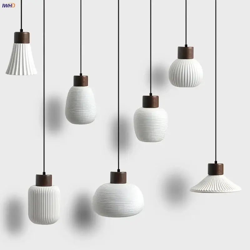 Modern white ceramic pendant light fixture with vertical ridges and dark wood accents for kitchen decor
