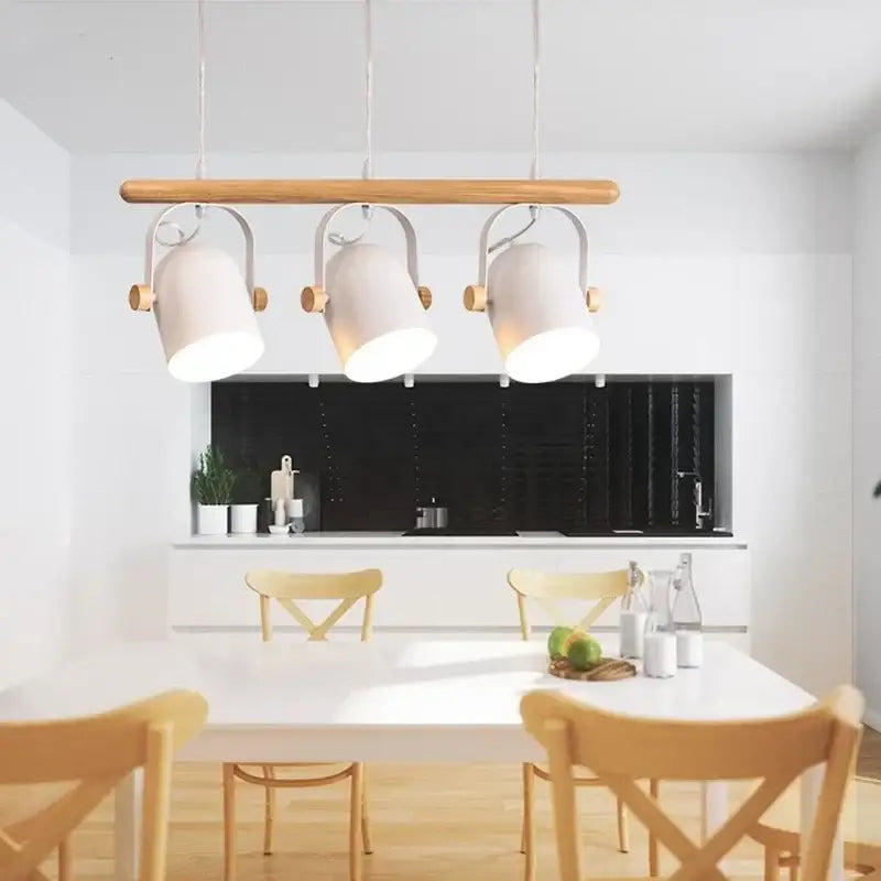 Modern white ceramic pendant lamp with wooden iron art accents hanging above a dining room table
