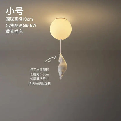 Modern white ceramic bear led ceiling light featuring a frosted glass globe with a white ceramic cat figurine hanging from its stem