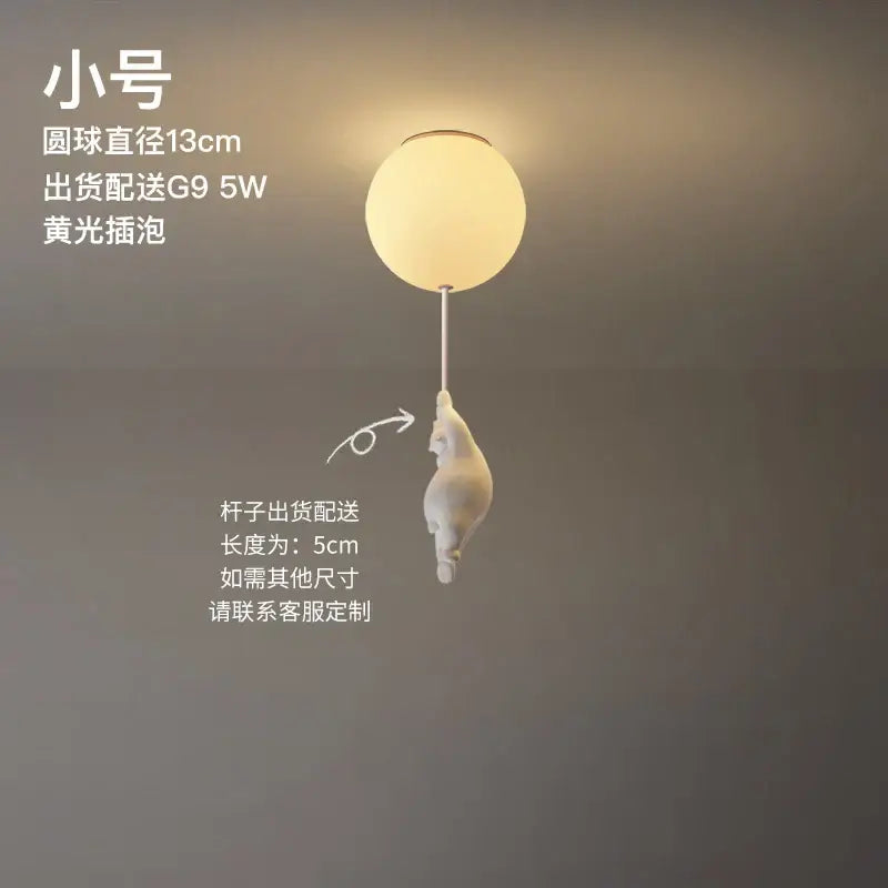 Modern white ceramic bear led ceiling light featuring a frosted glass globe with a white ceramic cat figurine hanging from its stem