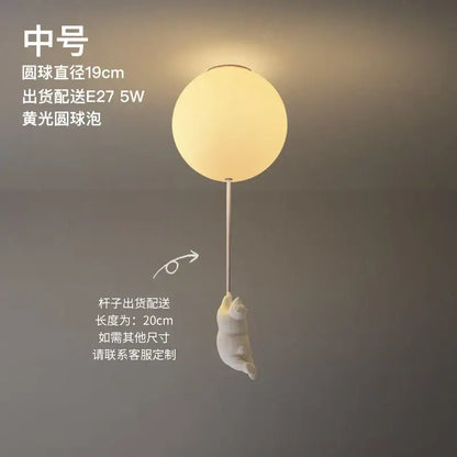 Modern white ceramic bear led ceiling light featuring a soft yellow spherical light with a white cat figurine for kids bedroom