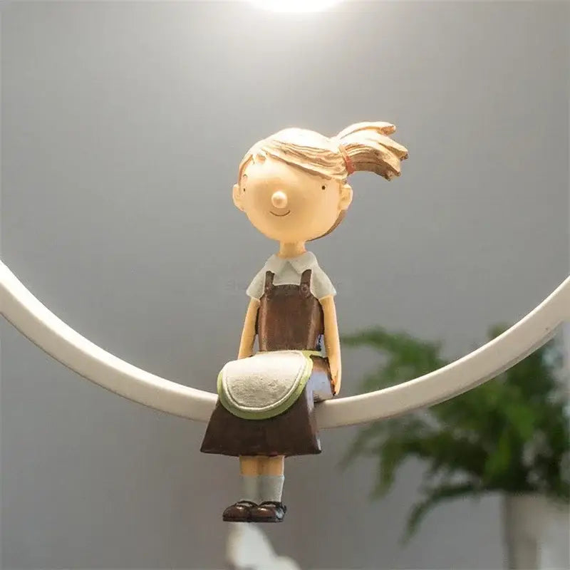 A beige resin figurine of a girl with blonde ponytail in brown overalls paired with modern white ceramic bird iron ring pendant light decorbites iron ring pendant