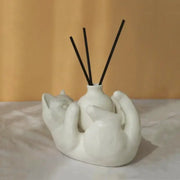 Modern white ceramic cat cartoon vase diffuser base shaped like two embracing cats with black reed sticks decorbites cat cartoon