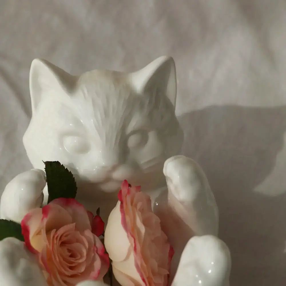 Modern white ceramic cat cartoon vase by decorbites holding pink and peach roses for living room reed diffuser base decor