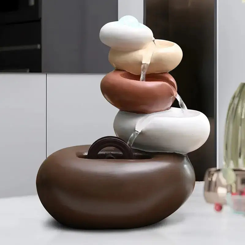 Modern white ceramic circulating water fountain with smooth stone-like layers in earthy tones for living room decorbites decor