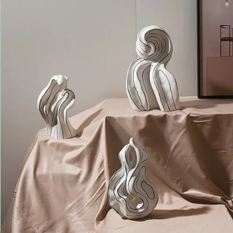 Modern white ceramic curl sculpture with flowing wave forms and black linear detailing for living room decor