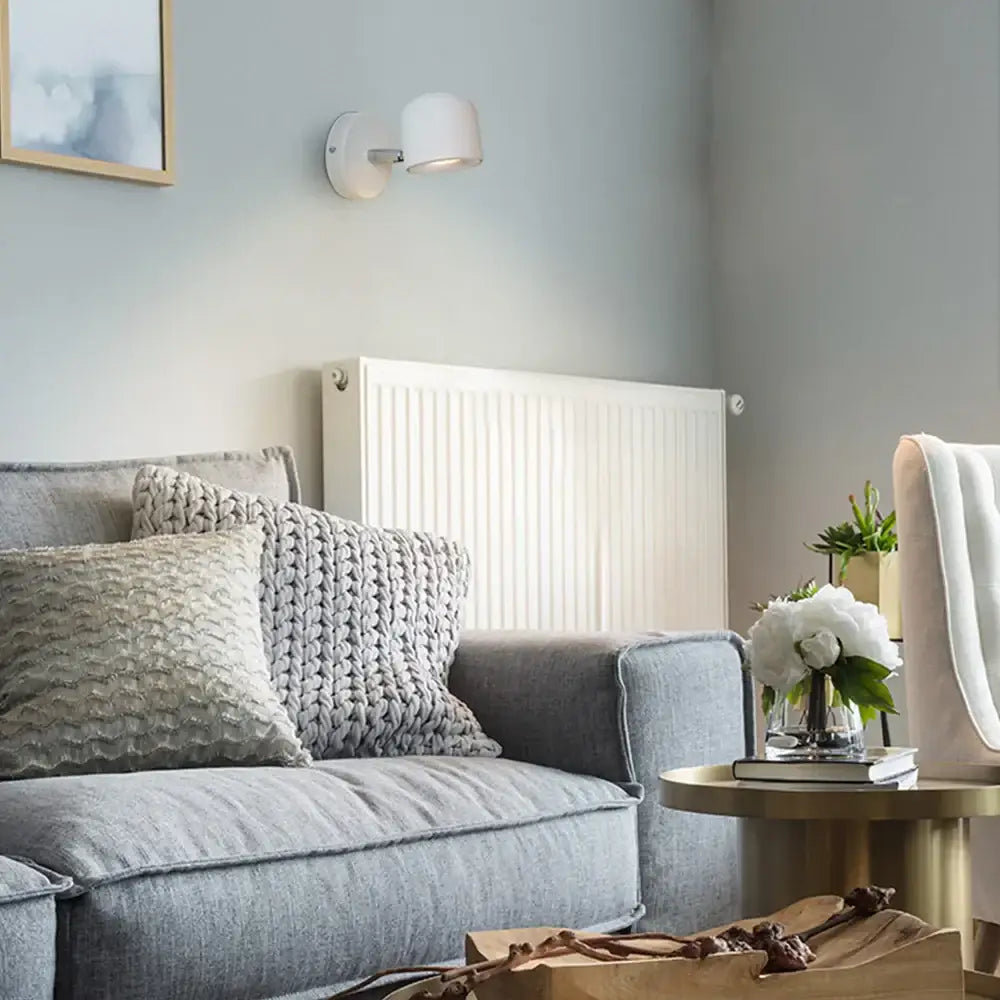 Modern white ceramic dimmable led wall lamp mounted above a gray textured knit throw pillow for bedroom reading light decorbites dimmable led wall