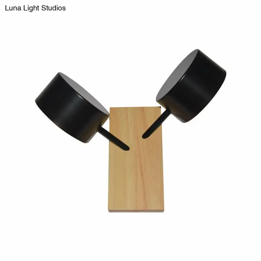 Modern black metal wall sconce with two adjustable arms on wooden base complementing 110v-120v double drum kitchen light