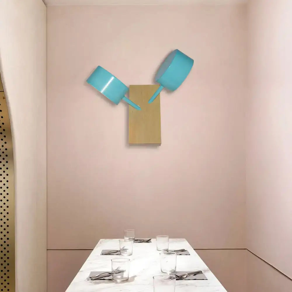 Two turquoise metallic cooking pots mounted as wall art sculpture complement modern white ceramic double drum wall sconce 110v-120v