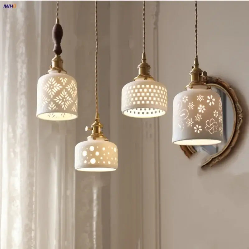 Three elegant white ceramic flower pendant lamps with brass accents and intricate cut-out patterns for kitchen led lighting