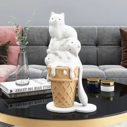 Modern white ceramic ice cream cat sculpture featuring three stacked cats inside a waffle cone with melting ice cream