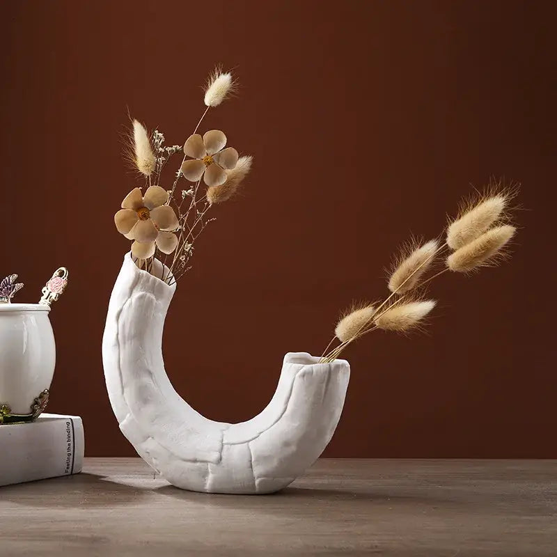 Modern white ceramic infinity symbol vase with curved textured design holding dried flowers for decorbites infinity decor