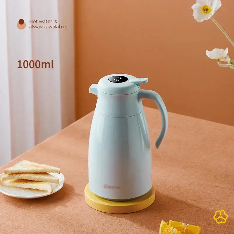 A sleek light blue 1000ml decorbites insulation kettle with matte finish and soft handle on yellow base