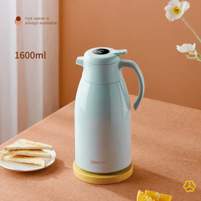 A sleek light blue 1600ml digital decorbites insulation kettle with ergonomic handle and ceramic body on yellow base